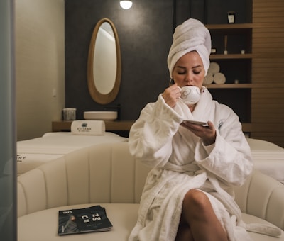 Woman relaxing in white spa robe